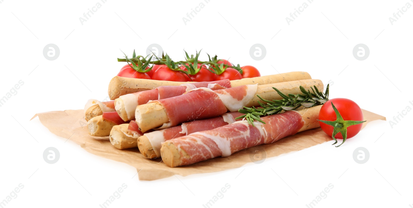 Photo of Delicious grissini sticks with prosciutto, tomatoes and rosemary on white background