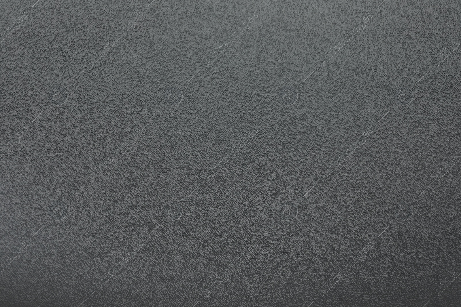 Photo of Texture of dark grey leather as background, closeup