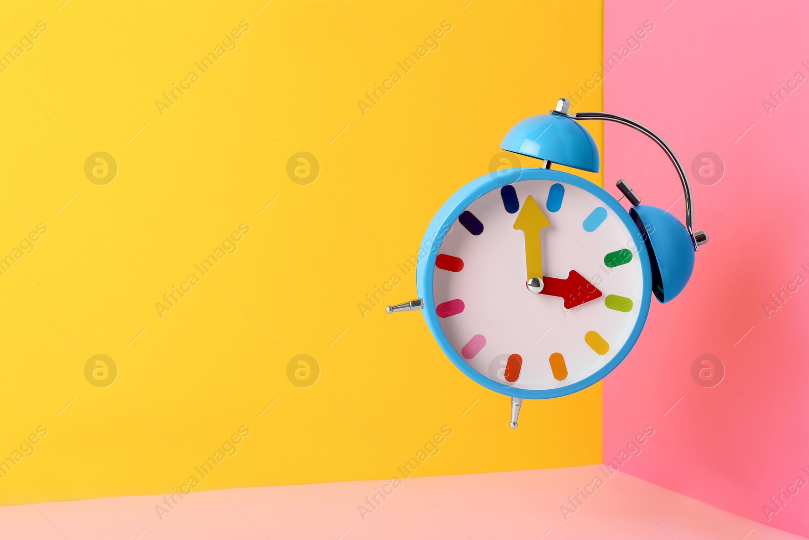 Photo of Alarm clock on color background. Space for text