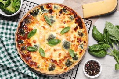 Delicious homemade salmon quiche and ingredients on table, flat lay