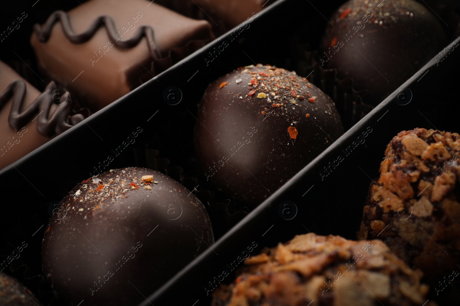Photo of Many different chocolate candies in box, closeup