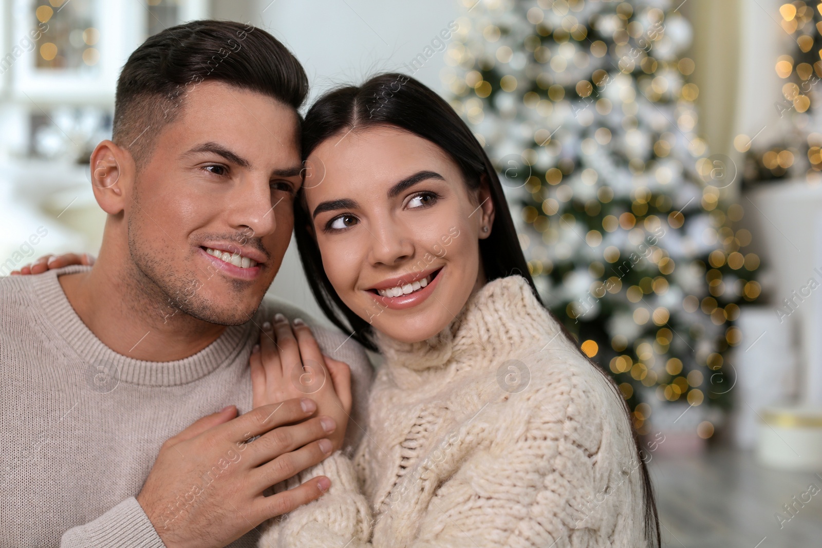 Photo of Happy couple in festively decorated room. Christmas celebration