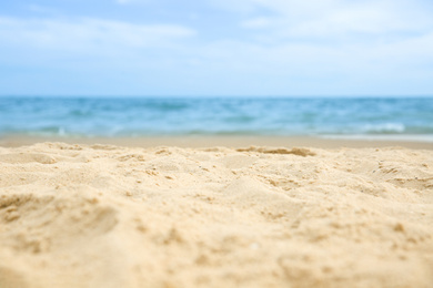 Photo of Beautiful sandy beach and sea on sunny day, closeup. Summer vacation