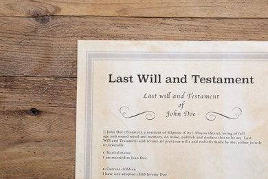 Photo of Last Will and Testament on wooden table, top view