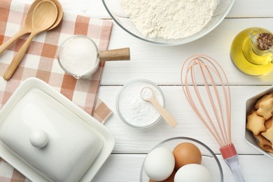 Flat lay composition with baking powder and products on white wooden table