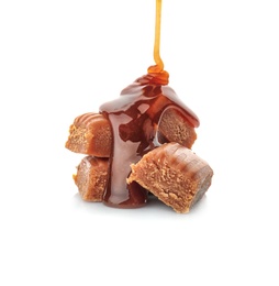 Photo of Pouring caramel sauce onto delicious candies on white background