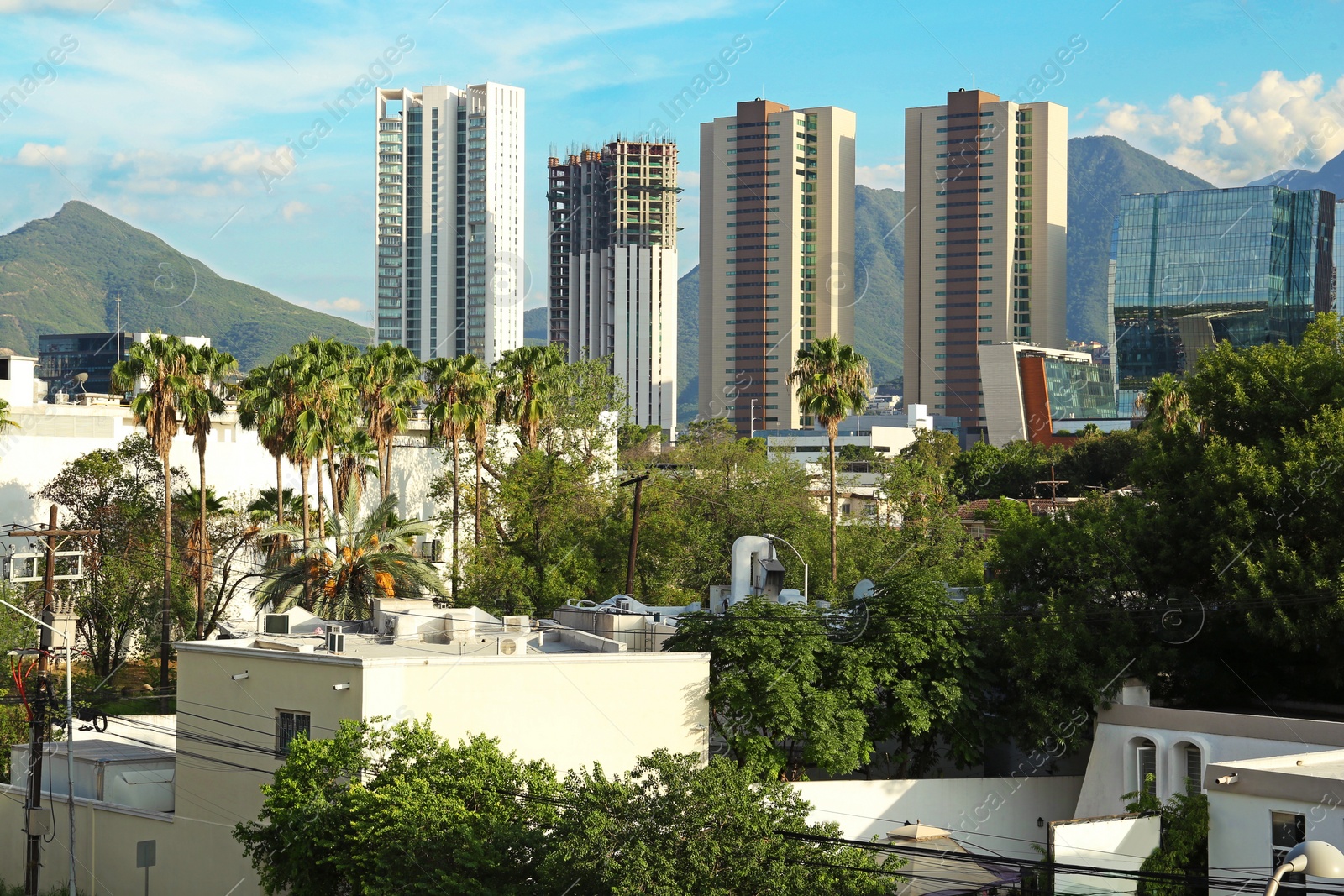 Photo of Picturesque view of mountains and city with skyscrapers