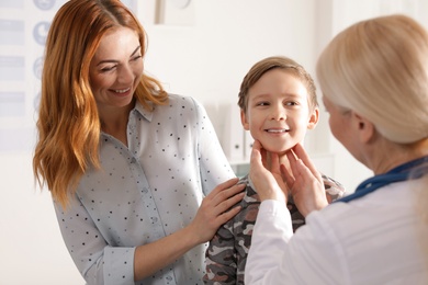 Photo of Mother with child visiting doctor in hospital