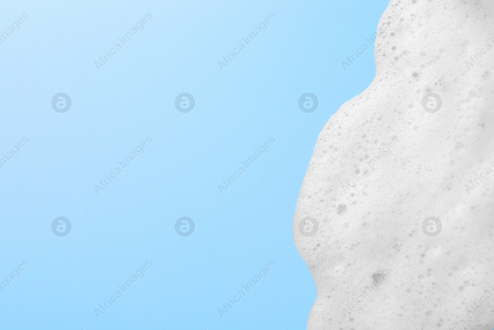 Photo of Foam sample on light blue background, top view. Space for text