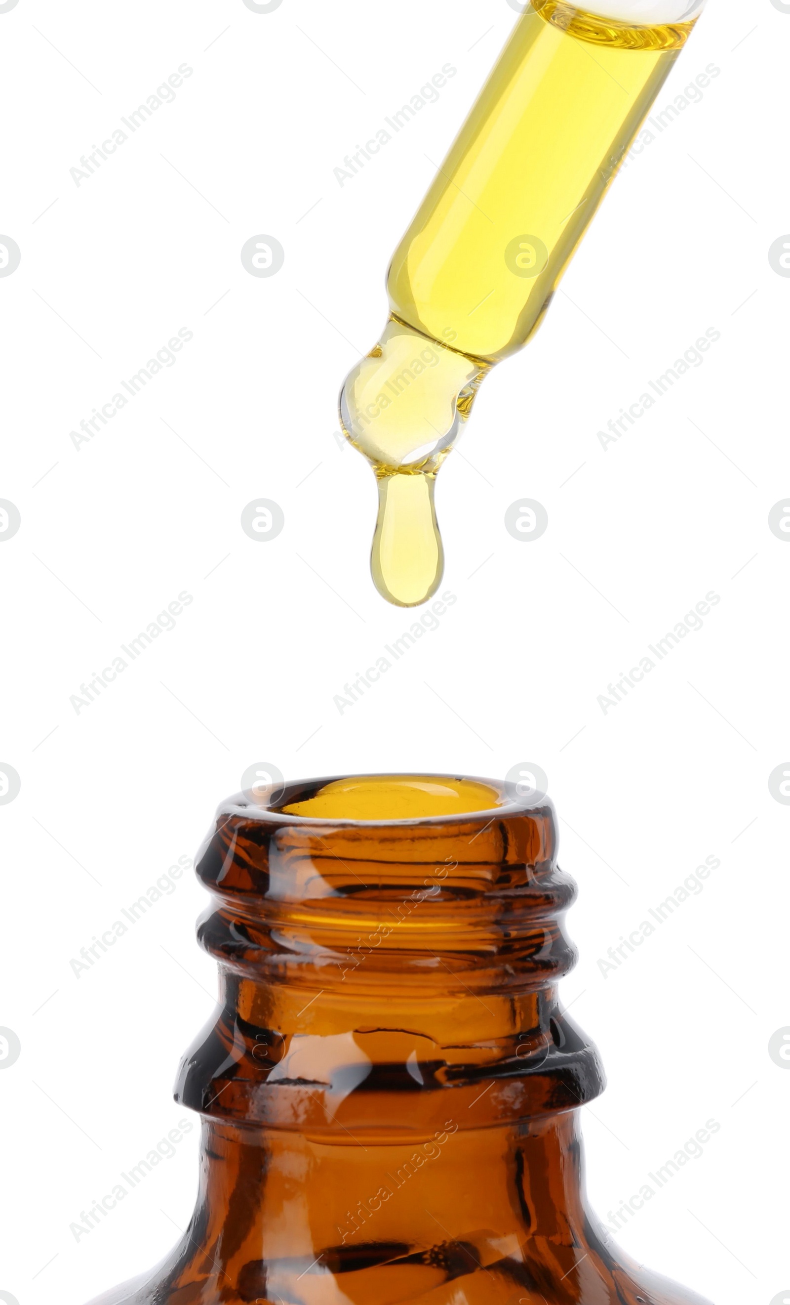 Photo of Dripping tincture from pipette into bottle isolated on white