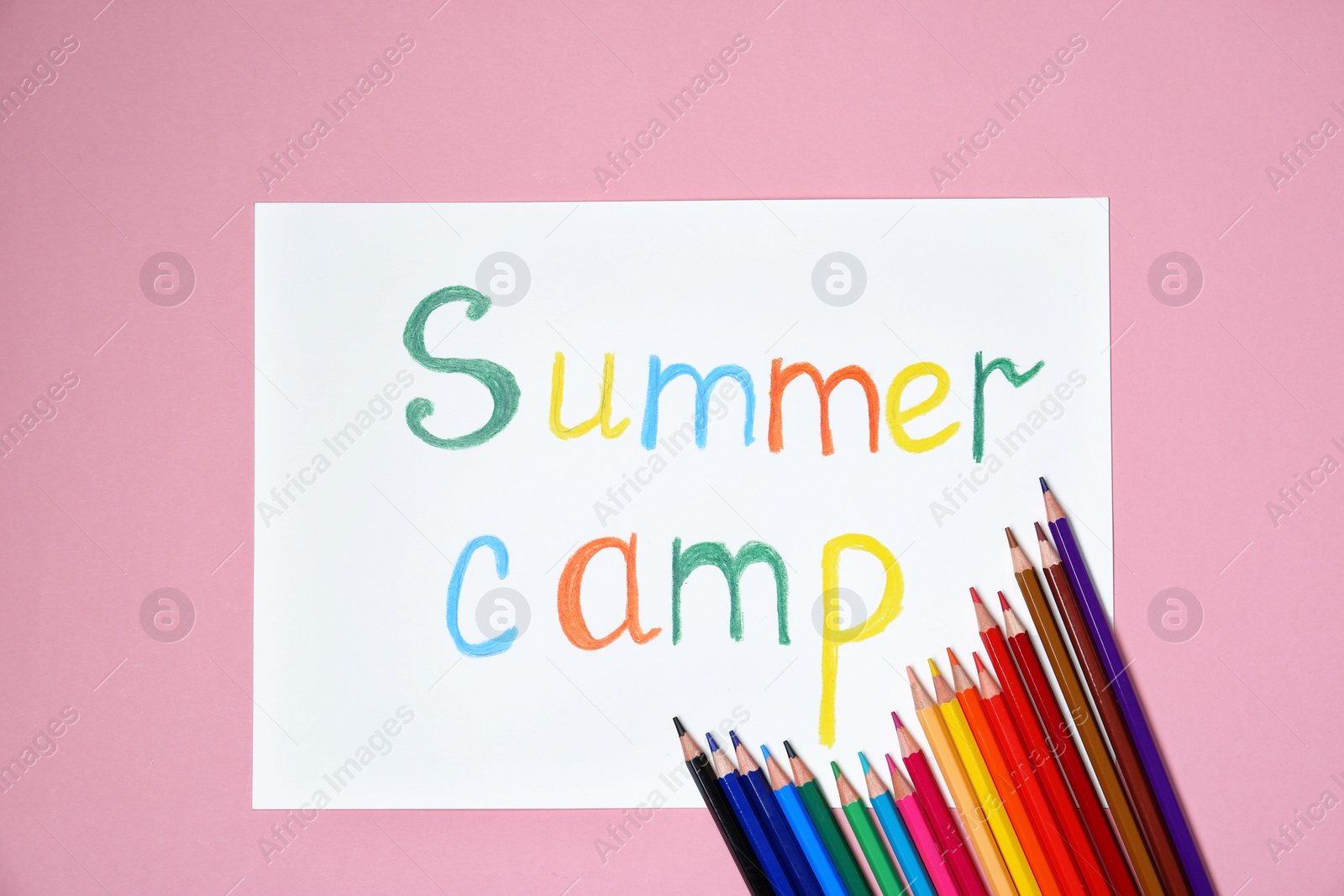 Photo of Pencils and words SUMMER CAMP on color background, top view