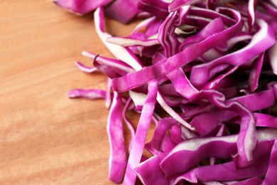 Sliced fresh red cabbage on wooden table, closeup