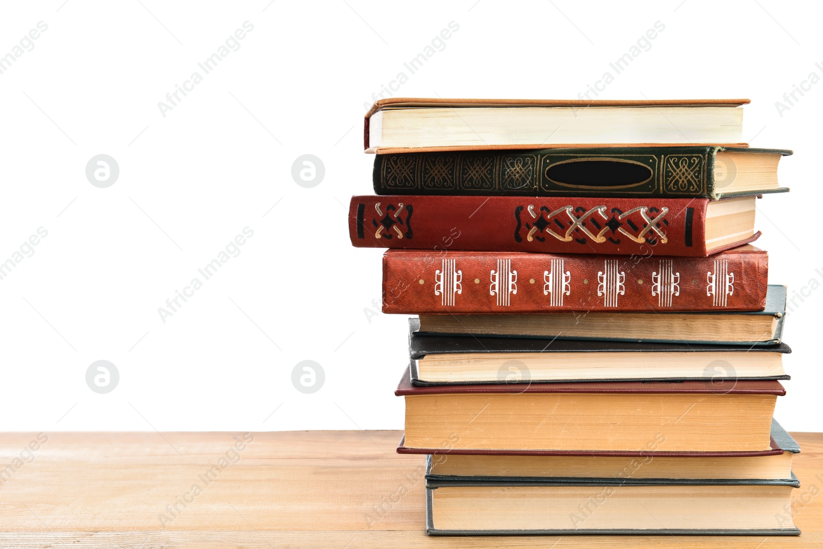 Photo of Stack of old vintage books on wooden table against white background