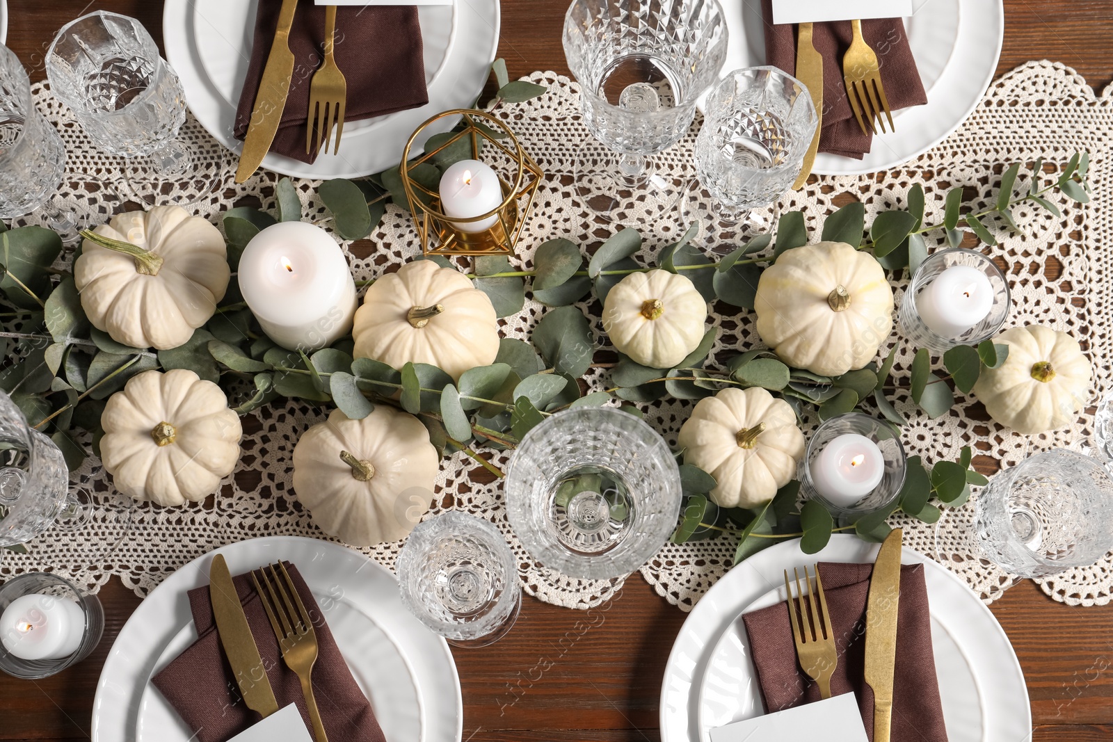 Photo of Beautiful autumn table setting. Plates, cutlery, glasses, blank cards and floral decor, flat lay