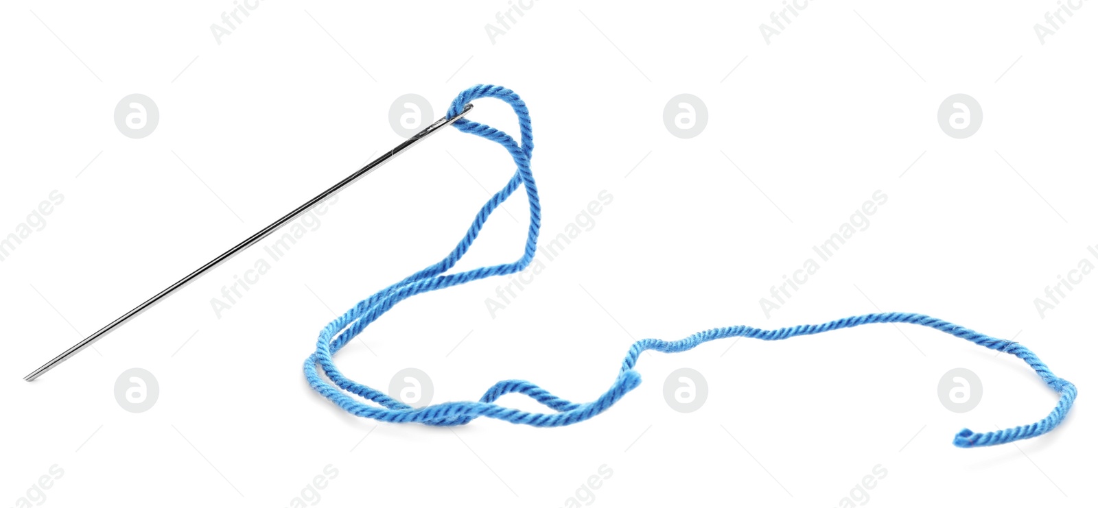 Photo of Sewing needle with light blue thread isolated on white