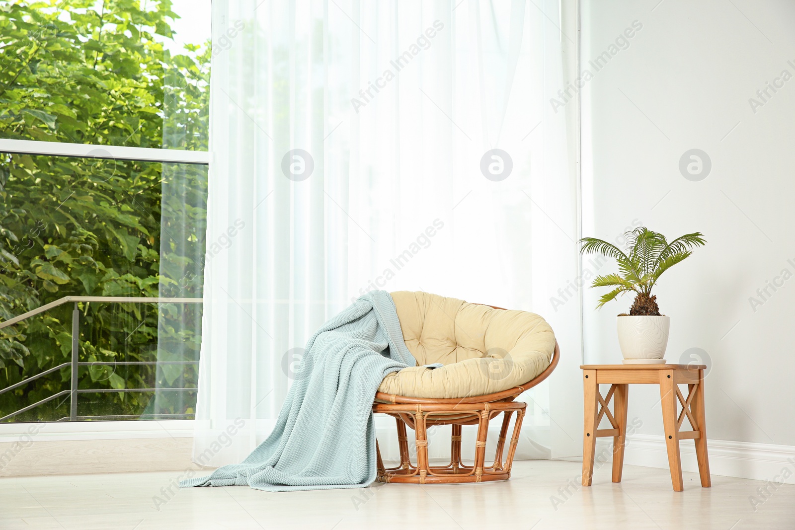 Photo of Living room interior with round lounge chair near window