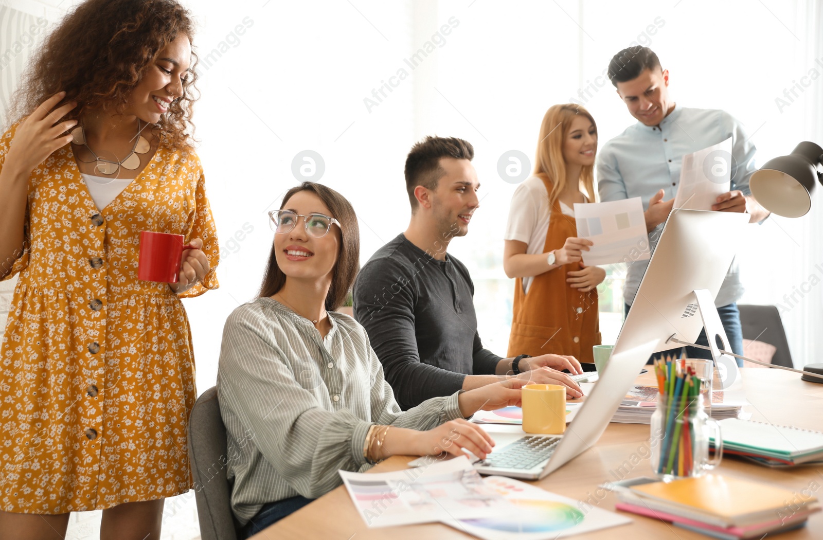 Photo of Team of professional designers working in office