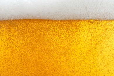 Glass of tasty beer with foam, closeup