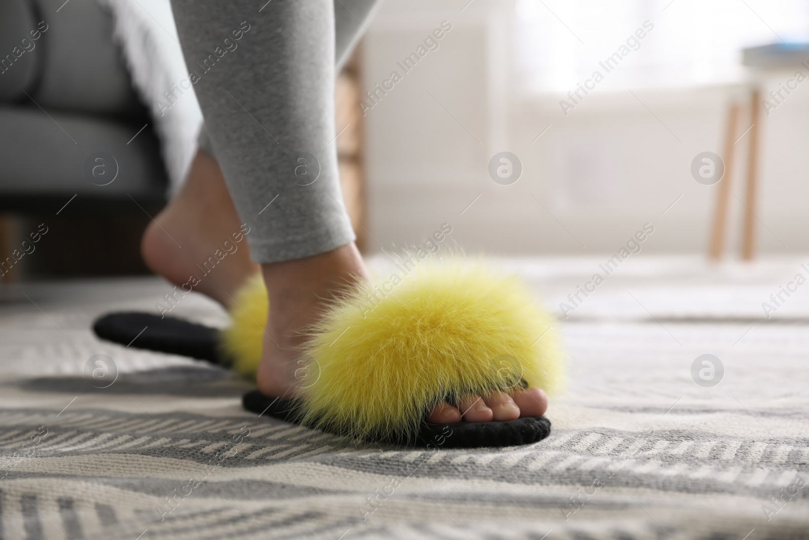 Photo of Woman wearing stylish soft slippers at home, closeup