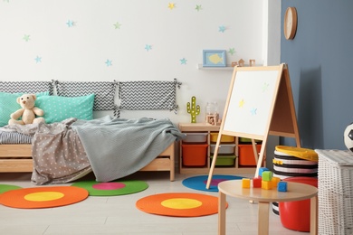 Photo of Modern child room interior with comfortable bed