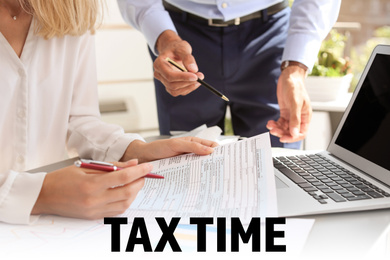 Tax accountants working with documents at table, closeup