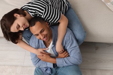 Photo of Dating agency. Happy couple enjoying time together at home, above view