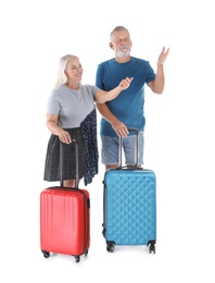 Photo of Senior couple with suitcases on white background. Vacation travel