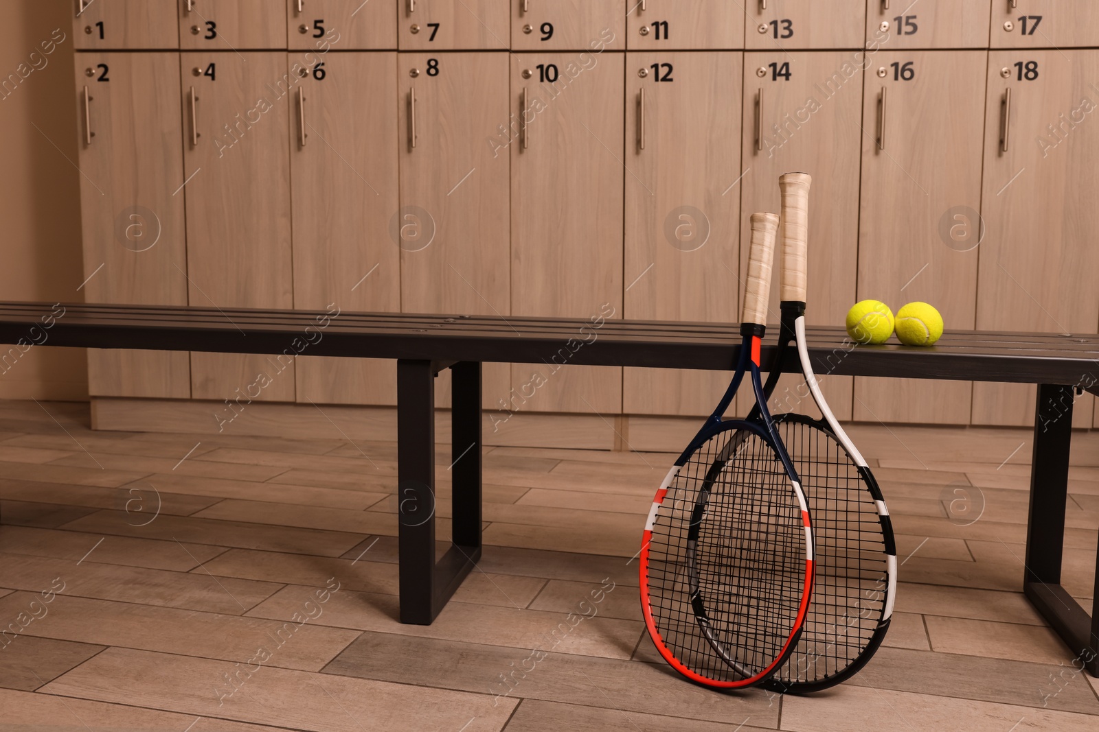 Photo of Tennis racket and balls in locker room