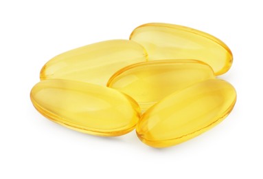 Photo of Many yellow vitamin capsules isolated on white