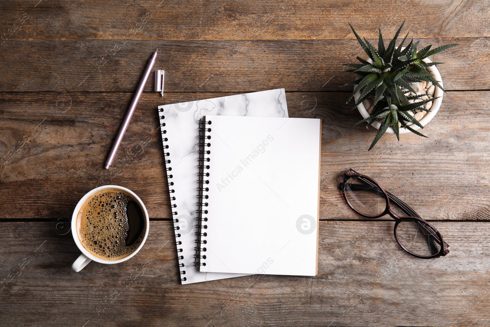 Photo of Flat lay composition with notebooks, coffee and plant on wooden background