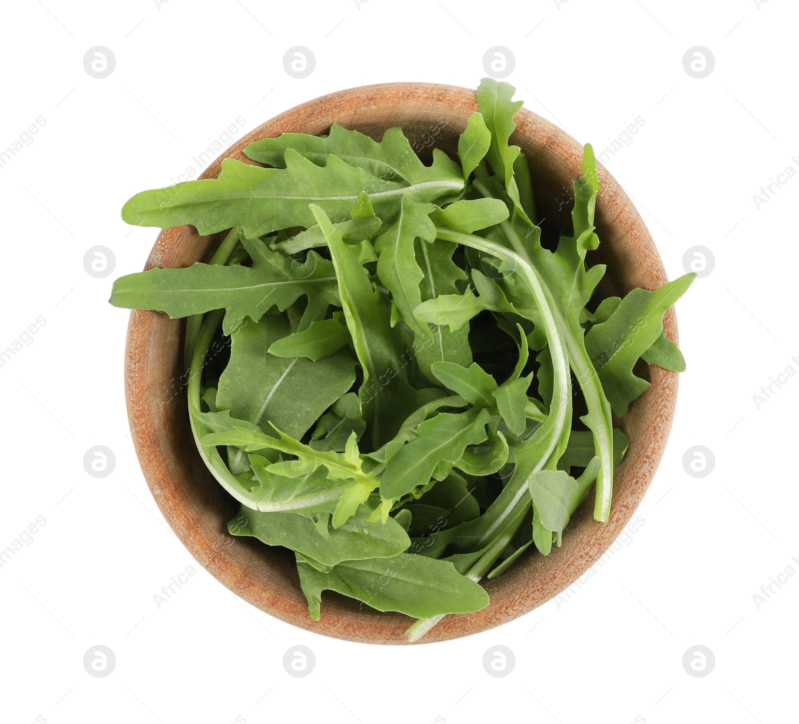 Photo of Delicious fresh arugula in wooden bowl isolated on white, top view