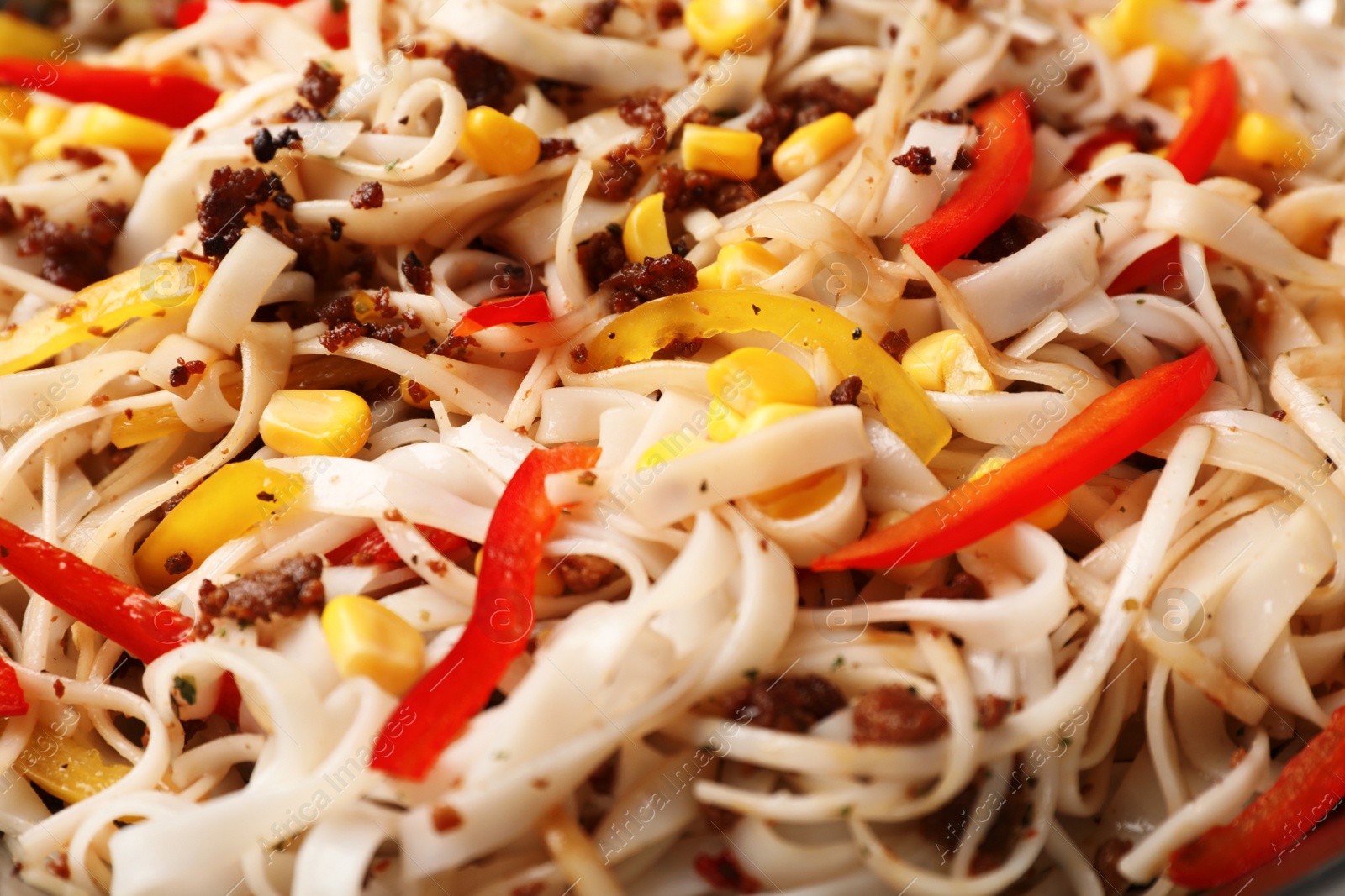 Photo of Rice noodles with meat and vegetables as background, closeup