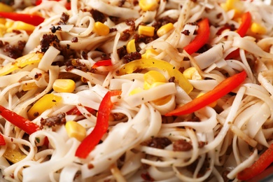 Photo of Rice noodles with meat and vegetables as background, closeup