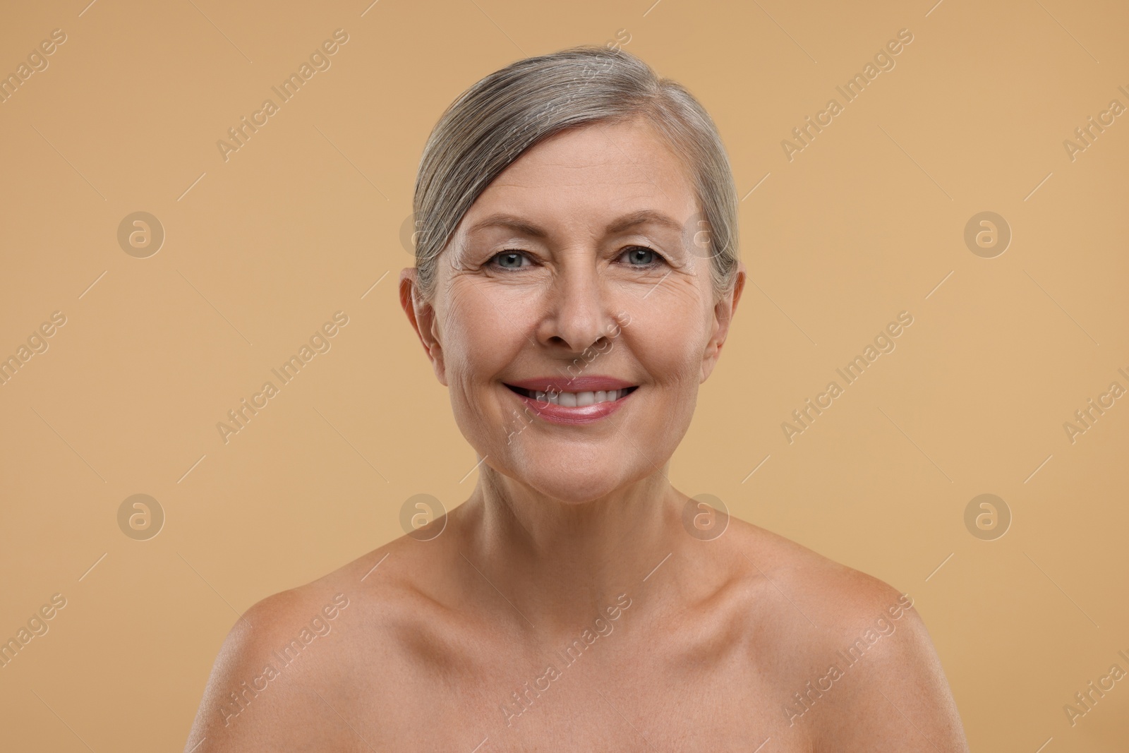 Photo of Beautiful woman with healthy skin on beige background