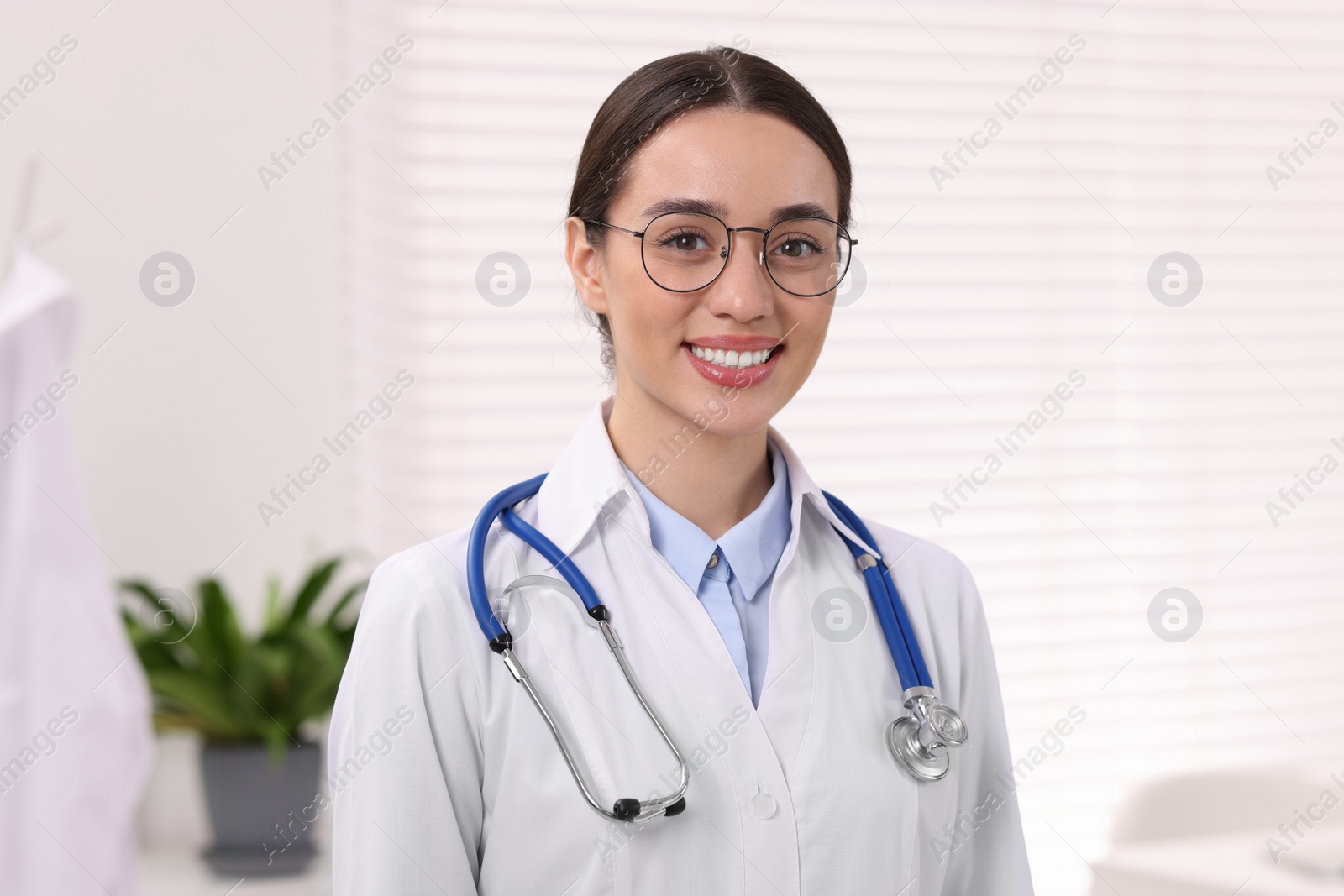 Photo of Medical consultant with glasses and stethoscope in clinic