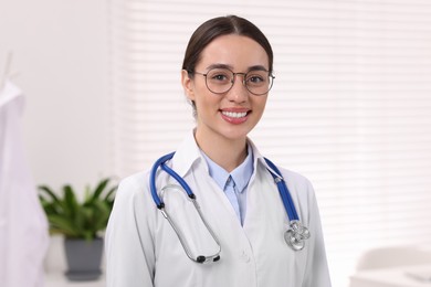 Photo of Medical consultant with glasses and stethoscope in clinic