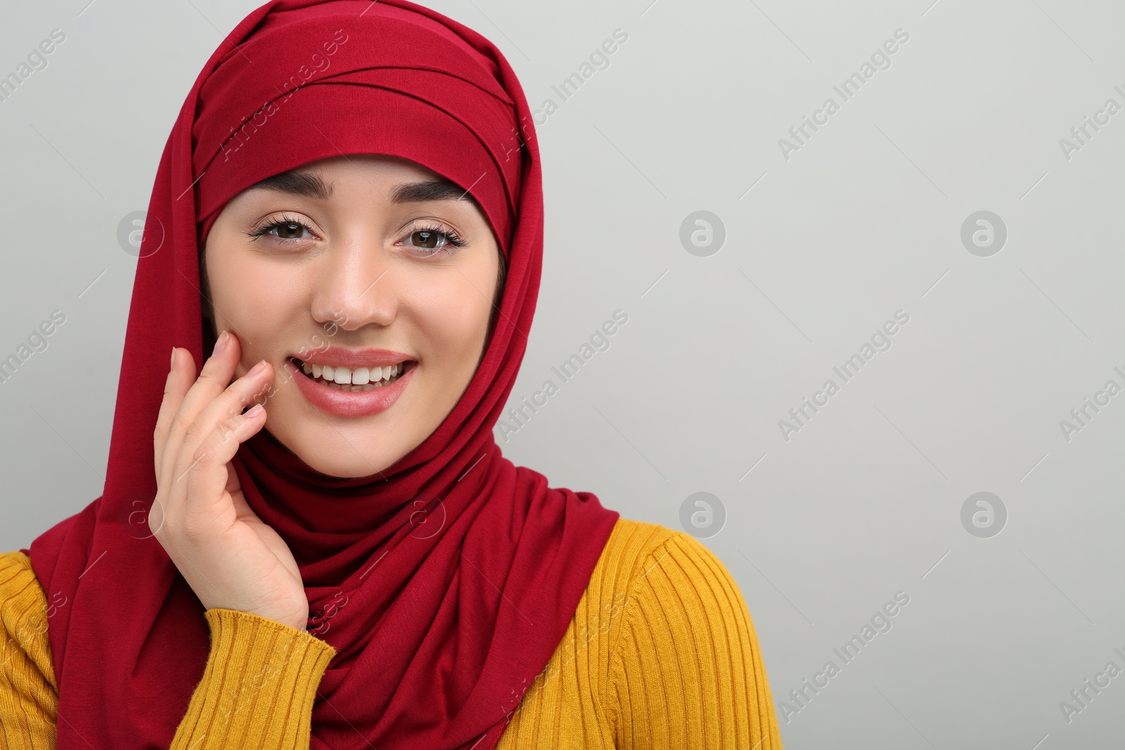Photo of Muslim woman in hijab on light gray background, space for text