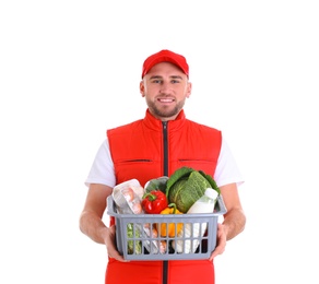 Delivery man holding plastic crate with food products on white background