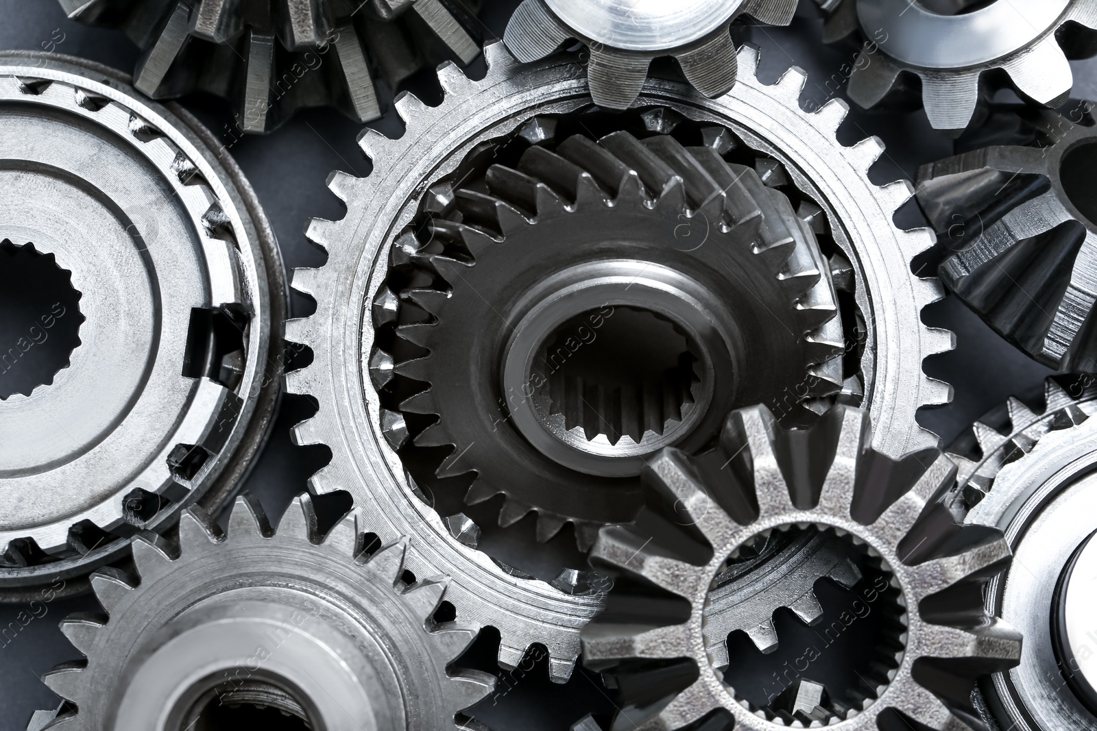 Photo of Many different stainless steel gears as background, top view