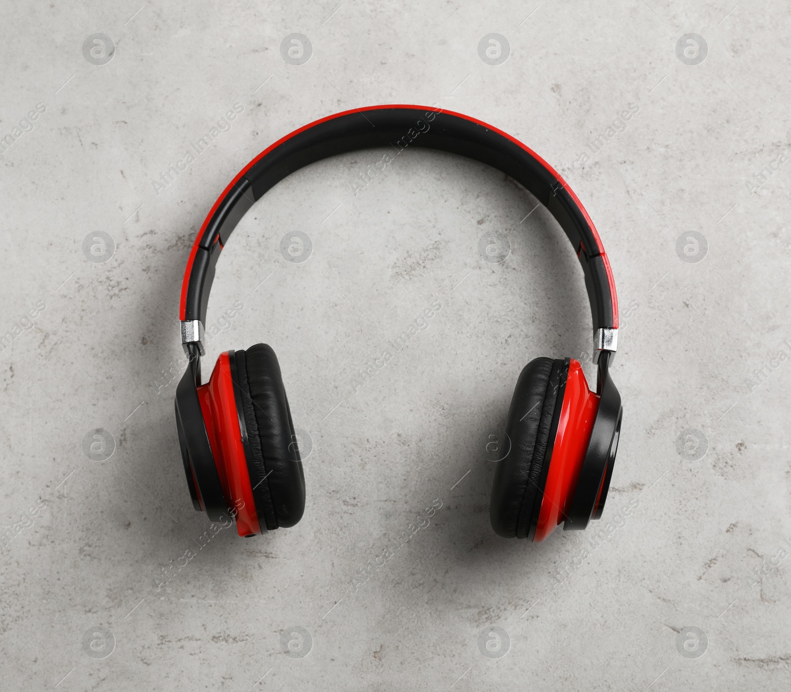 Photo of Stylish modern headphones on gray background, top view