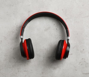 Photo of Stylish modern headphones on gray background, top view