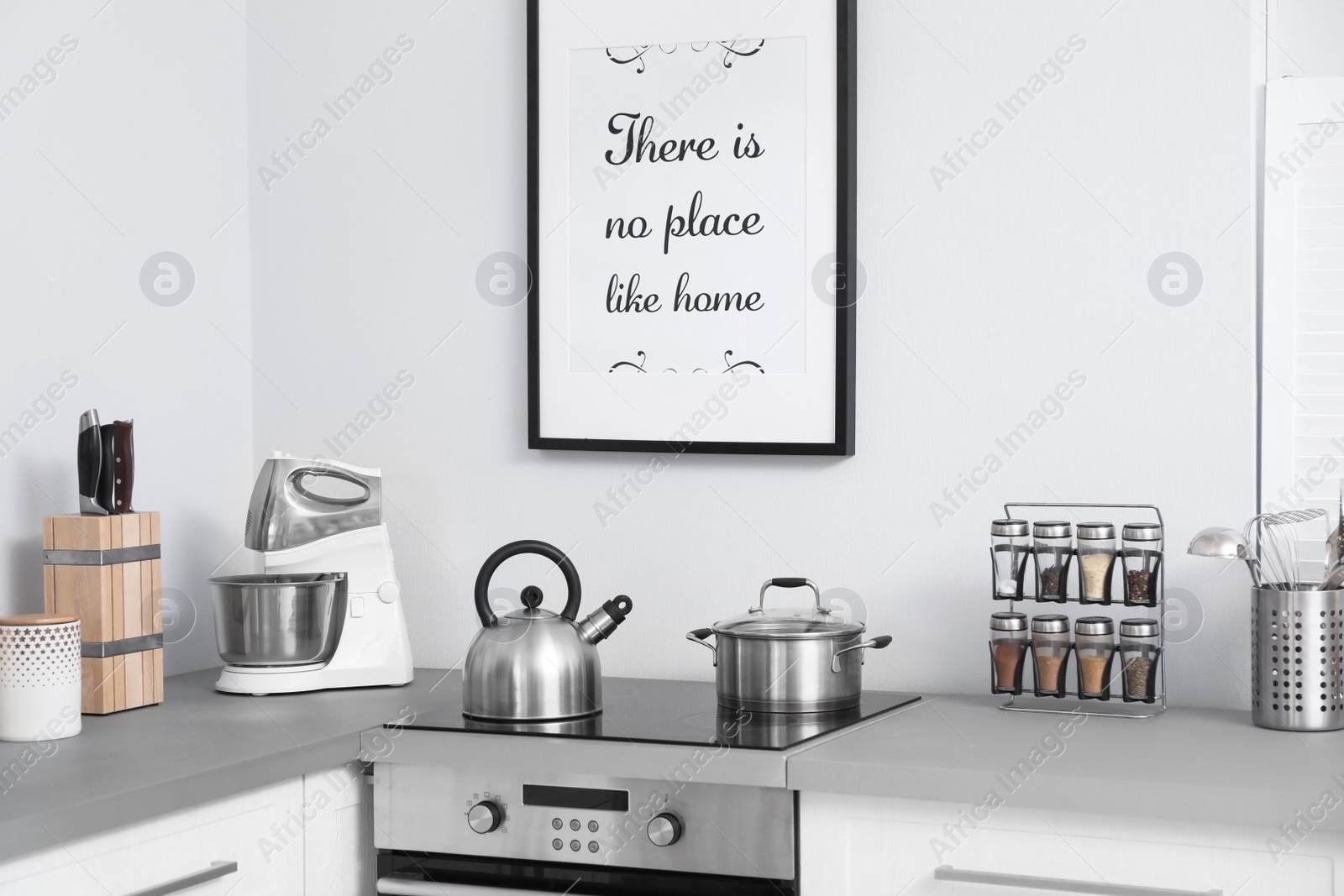 Photo of Modern kitchen interior with new furniture and different utensils