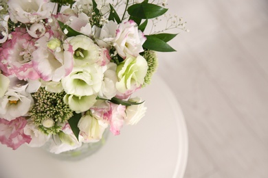 Photo of Bouquet of beautiful flowers on table in room, closeup with space for text. Interior design