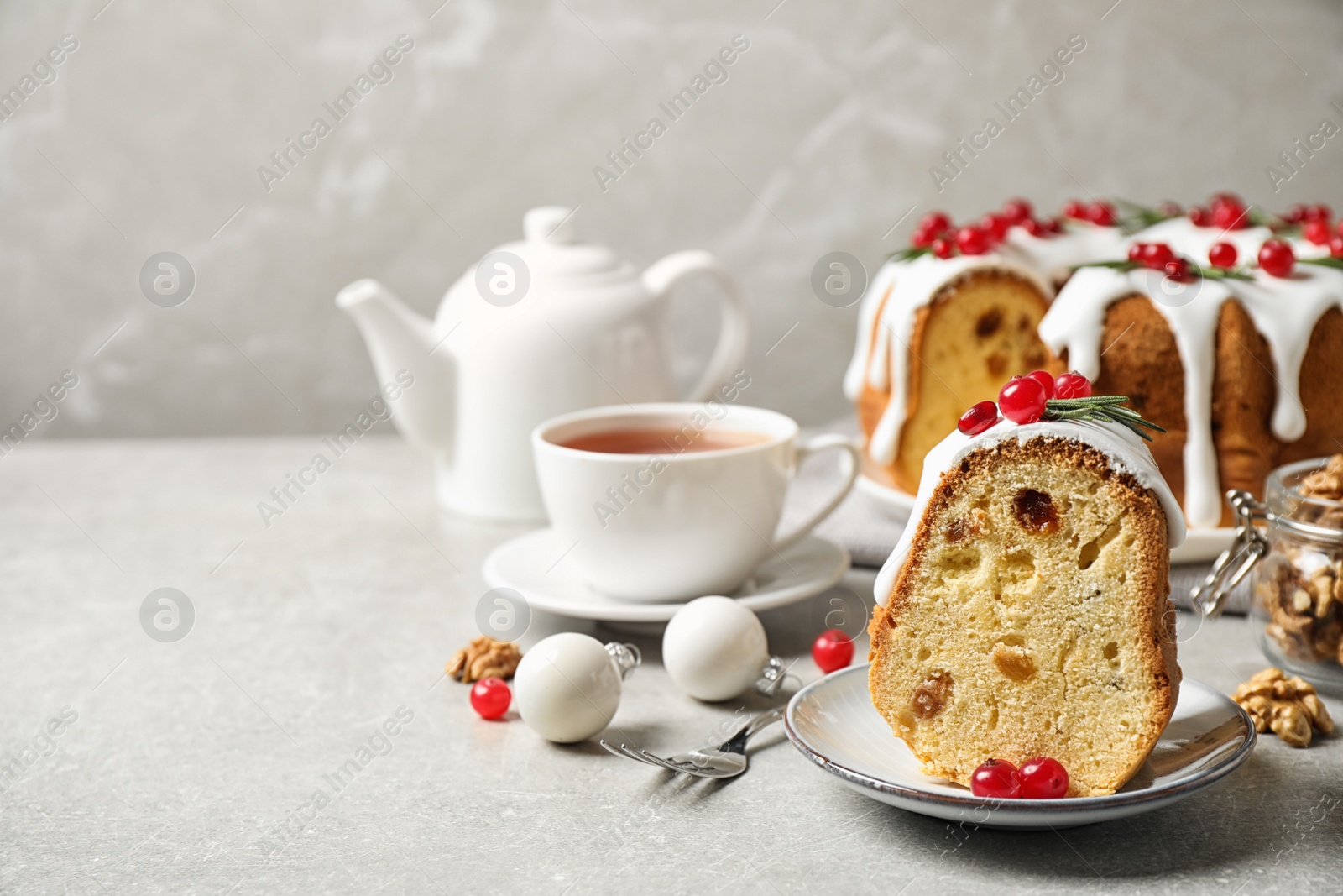 Photo of Composition with piece of traditional homemade Christmas cake on light grey table. Space for text