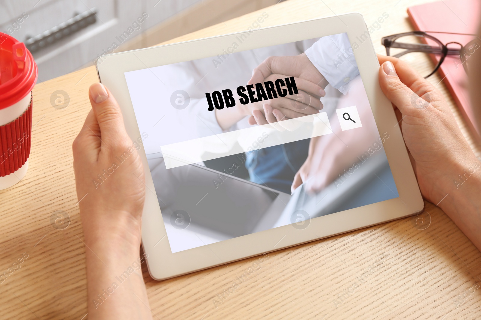 Image of Woman searching job on tablet at wooden table, closeup