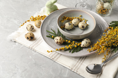 Photo of Festive Easter table setting with beautiful mimosa flowers