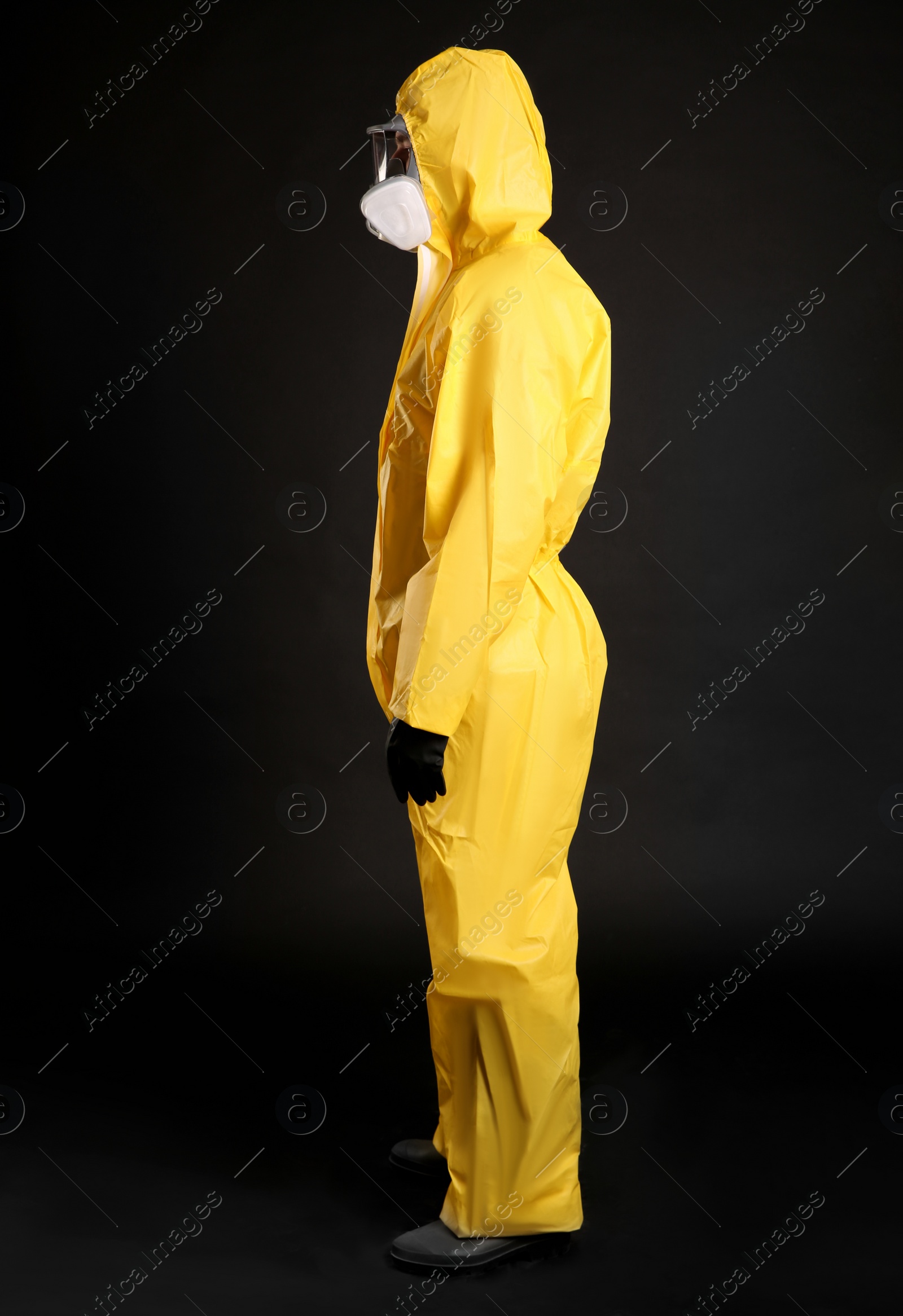 Photo of Man wearing chemical protective suit on black background. Virus research