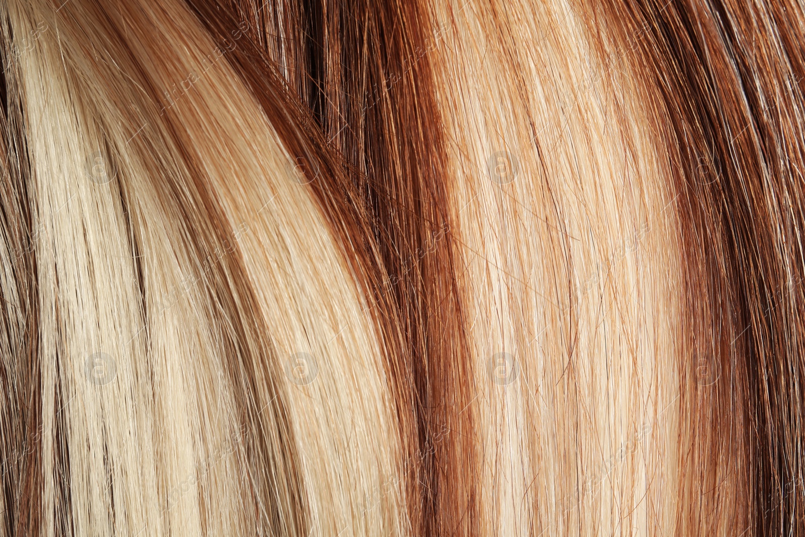 Photo of Strands of different color hair as background, closeup