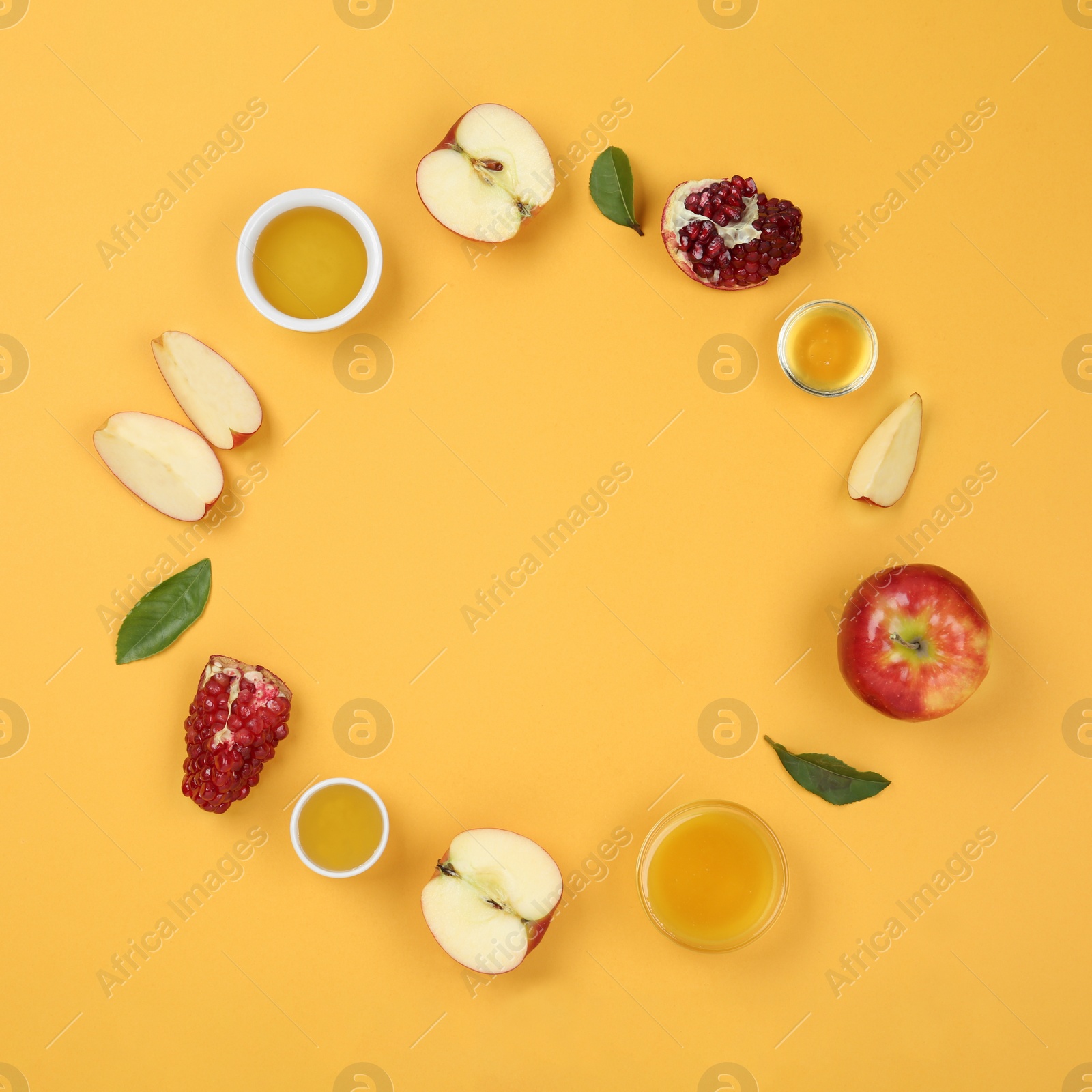 Photo of Flat lay composition with honey and fruits on orange background, space for text. Rosh Hashanah holiday