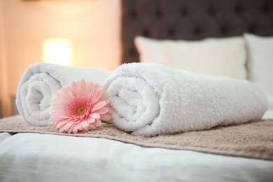 Photo of Clean towels on bed in hotel room